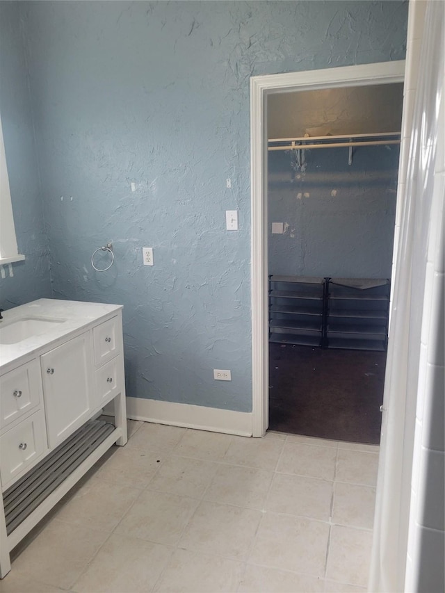 409 Forest Ave, Shreveport, LA 71104 - bathroom with vanity, tile patterned flooring, and a spacious closet
