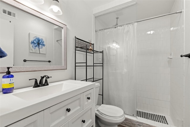 5925 E University Blvd Unit 133, Dallas, TX 75206 - full bath with vanity, visible vents, a stall shower, and toilet