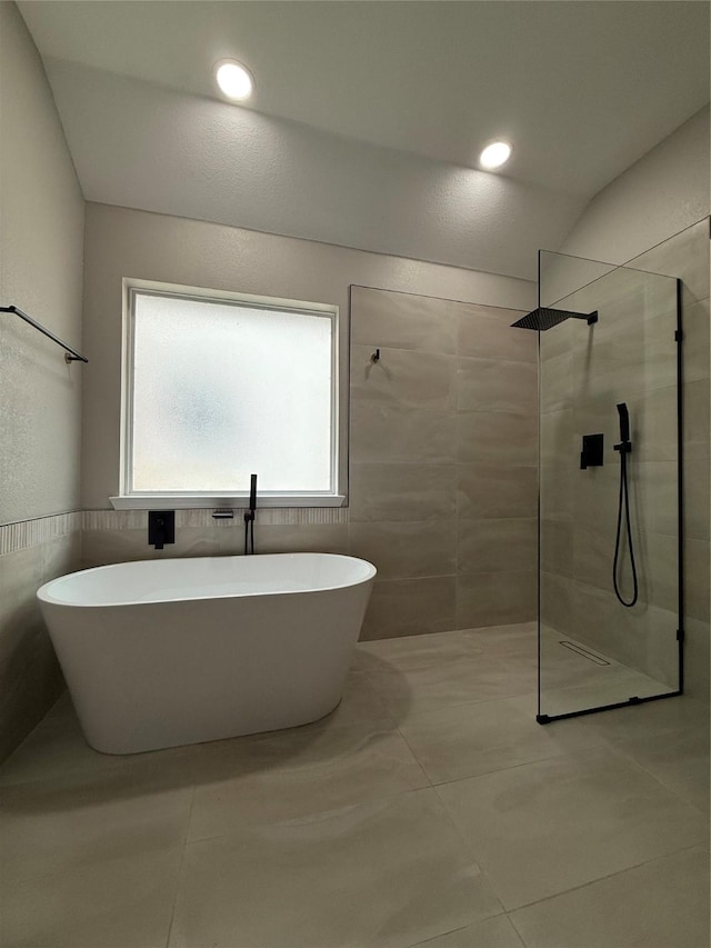 2610 Eganridge Ln, Rockwall, TX 75087 - bathroom featuring a walk in shower, a freestanding bath, tile patterned floors, and tile walls