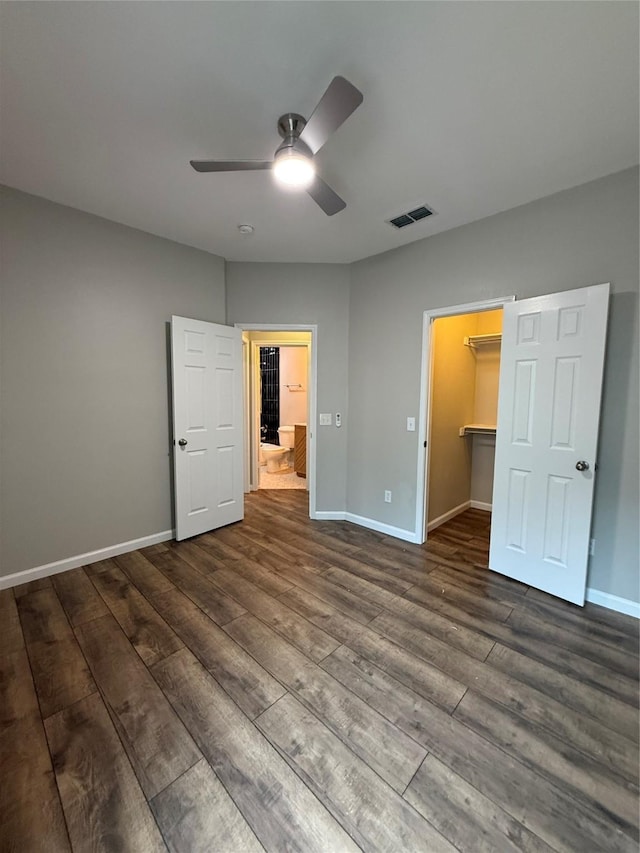 2610 Eganridge Ln, Rockwall, TX 75087 - unfurnished bedroom with a walk in closet, dark wood-style floors, and baseboards