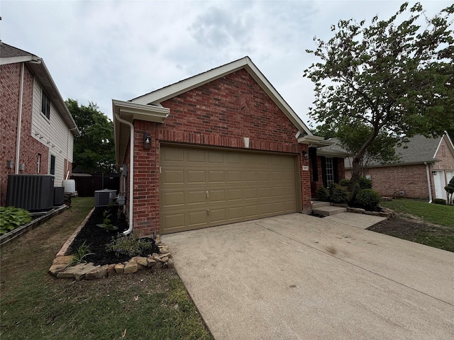 2610 Eganridge Ln, Rockwall, TX 75087 - view of front of property with central AC, brick siding, driveway, and a garage