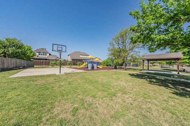 view of yard featuring a gazebo, playground community, and fence