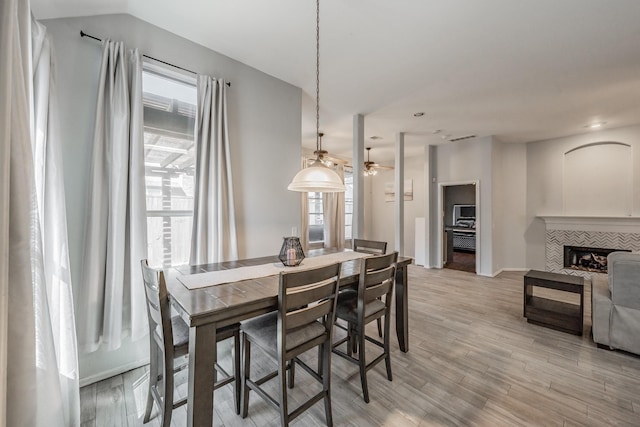 dining area with light wood-style floors, ceiling fan, baseboards, and visible vents