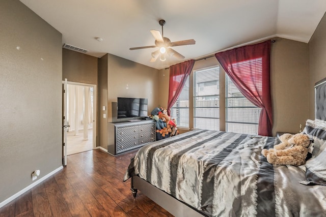 bedroom featuring visible vents, baseboards, ceiling fan, wood-type flooring, and lofted ceiling