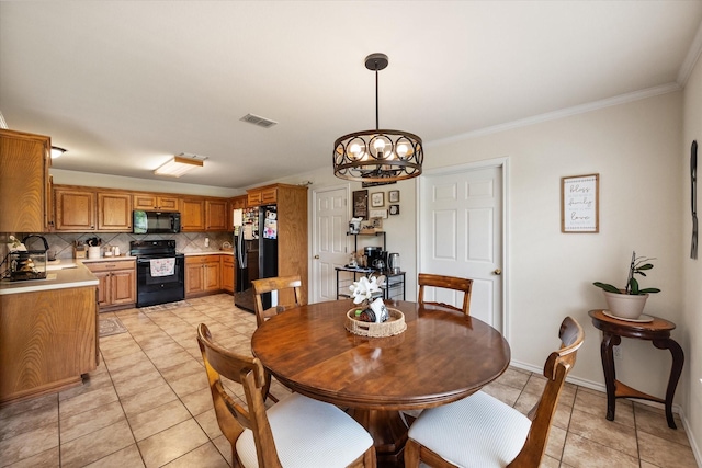 dining room with light tile patterned flooring, baseboards, visible vents, a chandelier, and crown molding