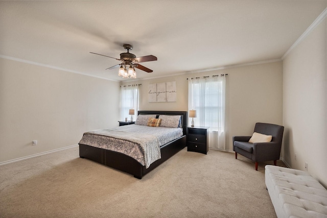 bedroom with carpet floors, crown molding, baseboards, and ceiling fan