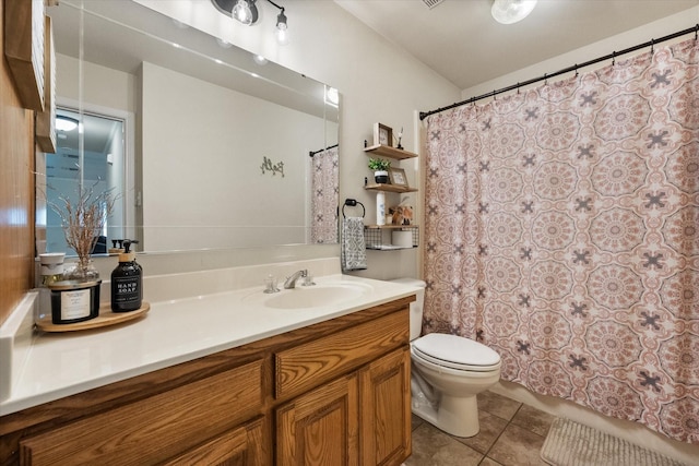 full bathroom featuring toilet, vanity, and tile patterned floors