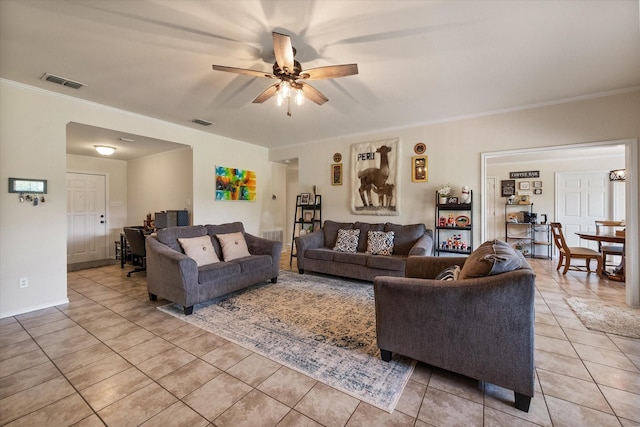 living area featuring ceiling fan, ornamental molding, visible vents, and light tile patterned floors