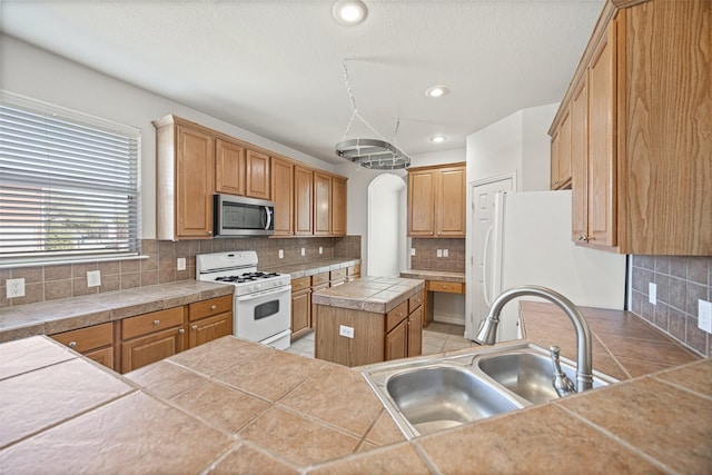 1919 Water Fall Way, Wylie, TX 75098 - kitchen with white appliances, a sink, backsplash, recessed lighting, and a kitchen island