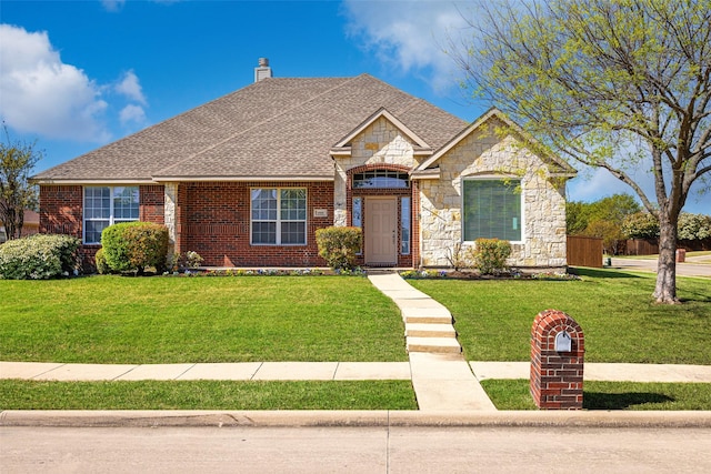 1919 Water Fall Way, Wylie, TX 75098 - view of front of house with a chimney, a front yard, brick siding, and stone siding