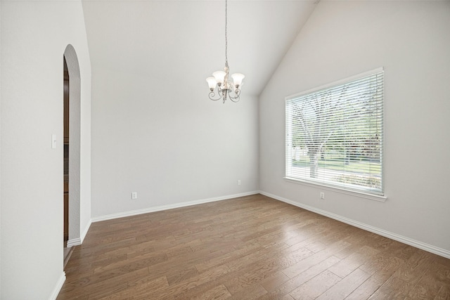 1919 Water Fall Way, Wylie, TX 75098 - spare room with arched walkways, wood finished floors, a chandelier, baseboards, and vaulted ceiling