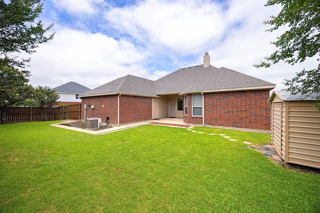 1919 Water Fall Way, Wylie, TX 75098 - back of house with brick siding, a patio, a chimney, a shingled roof, and central AC unit