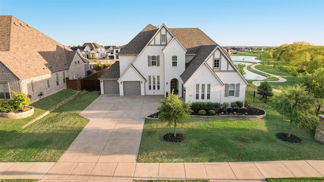 3101 Twin Eagles Dr, Celina, TX 75009 - french country home featuring a front yard, fence, driveway, and stucco siding