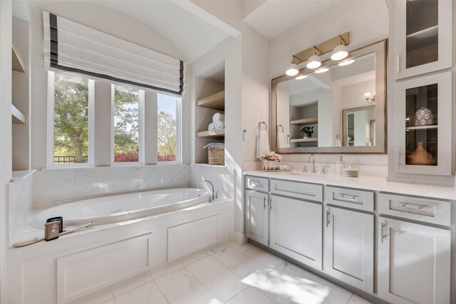 3101 Twin Eagles Dr, Celina, TX 75009 - bathroom with marble finish floor, a garden tub, vanity, and built in shelves