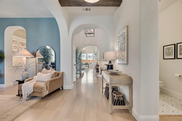 3101 Twin Eagles Dr, Celina, TX 75009 - hall featuring visible vents, arched walkways, a notable chandelier, and wood finished floors