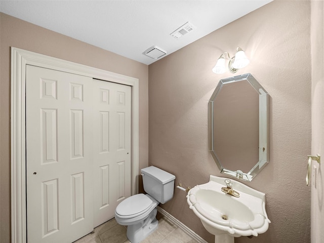 1213 Hills Creek Dr, Mckinney, TX 75072 - half bathroom with tile patterned floors, toilet, a sink, and baseboards