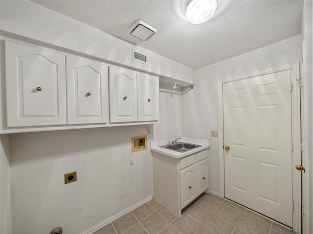 1213 Hills Creek Dr, Mckinney, TX 75072 - laundry room featuring electric dryer hookup, cabinet space, washer hookup, baseboards, and a textured ceiling