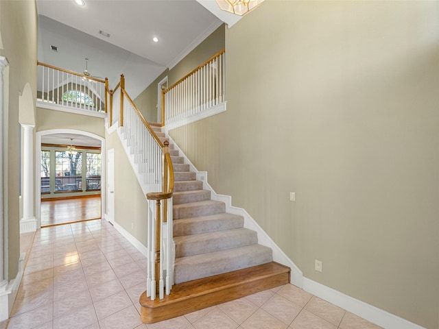 1213 Hills Creek Dr, Mckinney, TX 75072 - stairway with ornate columns, ceiling fan, tile patterned flooring, arched walkways, and recessed lighting