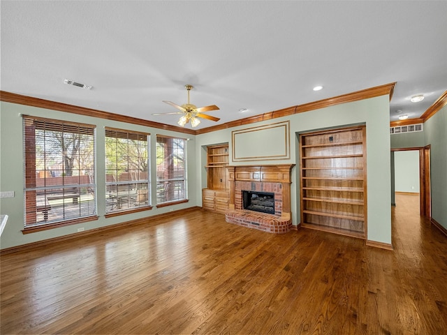 1213 Hills Creek Dr, Mckinney, TX 75072 - unfurnished living room featuring ornamental molding, wood finished floors, baseboards, ceiling fan, and a fireplace