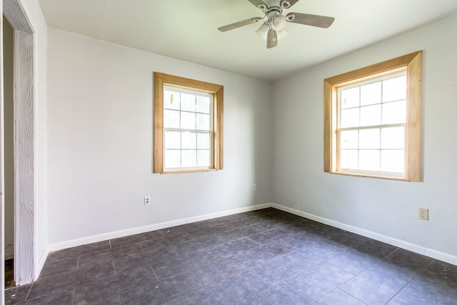 unfurnished room with baseboards and a ceiling fan