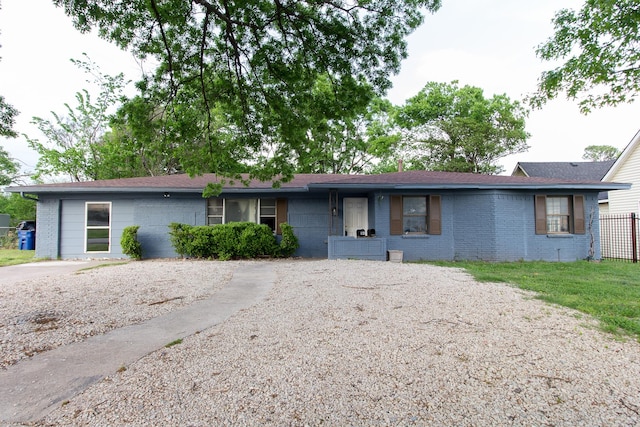 ranch-style home with roof with shingles and brick siding