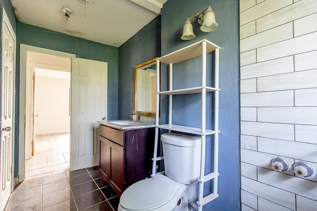 bathroom featuring toilet, tile patterned floors, and vanity