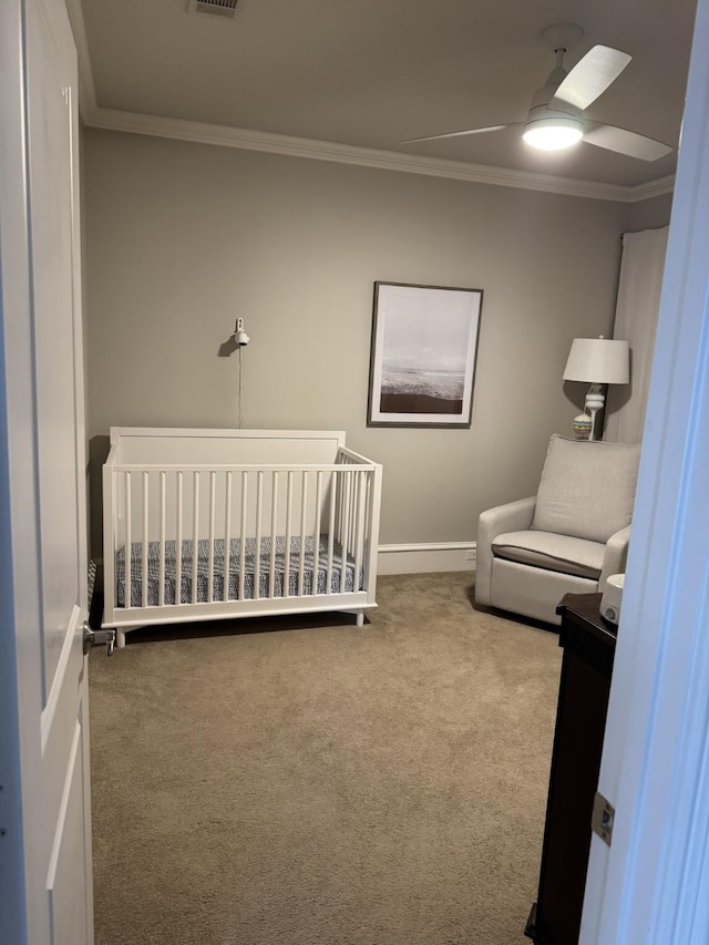 5123 Miller Ave, Dallas, TX 75206 - carpeted bedroom with baseboards, ornamental molding, a crib, a ceiling fan, and visible vents