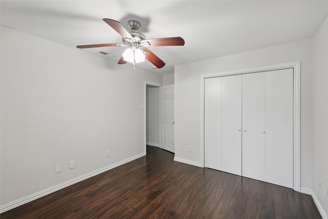 1951 Pin Oak Dr, Flower Mound, TX 75028 - unfurnished bedroom with baseboards, dark wood finished floors, a closet, and a ceiling fan