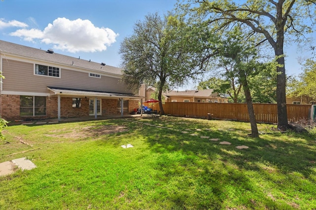view of yard featuring fence and a patio