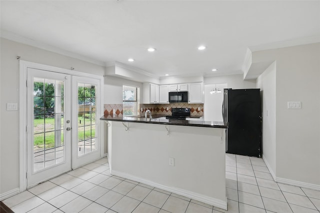 1951 Pin Oak Dr, Flower Mound, TX 75028 - kitchen with black appliances, white cabinets, french doors, backsplash, and dark countertops