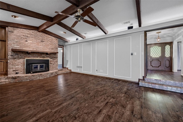 unfurnished living room featuring visible vents, a ceiling fan, lofted ceiling with beams, and dark wood finished floors