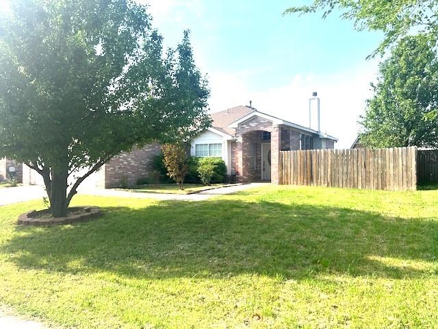518 Lonestar Park Ln, Ponder, TX 76259 - ranch-style house featuring a chimney, brick siding, fence, and a front lawn