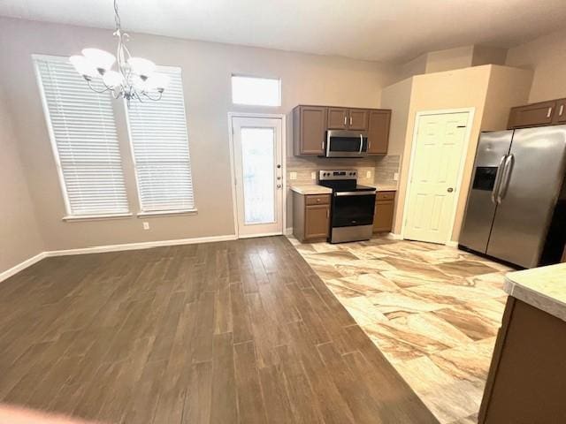 518 Lonestar Park Ln, Ponder, TX 76259 - kitchen featuring gray cabinets, a chandelier, appliances with stainless steel finishes, light countertops, and light wood-type flooring