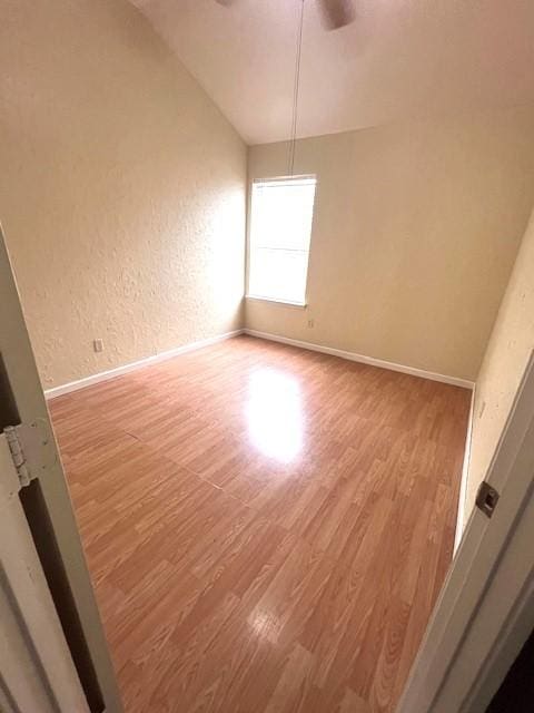 518 Lonestar Park Ln, Ponder, TX 76259 - unfurnished room with wood finished floors, lofted ceiling, a textured wall, and a ceiling fan