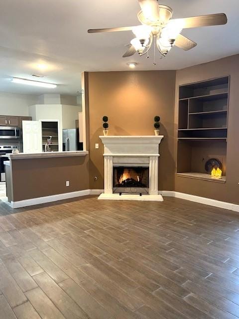 518 Lonestar Park Ln, Ponder, TX 76259 - unfurnished living room with dark wood-type flooring, ceiling fan, baseboards, and visible vents