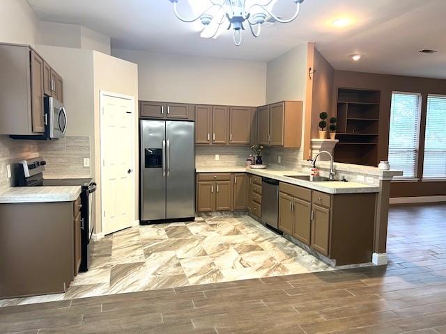 518 Lonestar Park Ln, Ponder, TX 76259 - kitchen with an inviting chandelier, appliances with stainless steel finishes, light countertops, light wood finished floors, and gray cabinetry