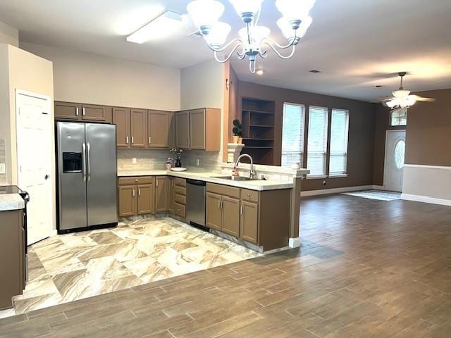 518 Lonestar Park Ln, Ponder, TX 76259 - kitchen with a sink, stainless steel appliances, a peninsula, light countertops, and ceiling fan with notable chandelier