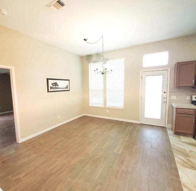 518 Lonestar Park Ln, Ponder, TX 76259 - unfurnished dining area featuring a chandelier and light wood-style flooring