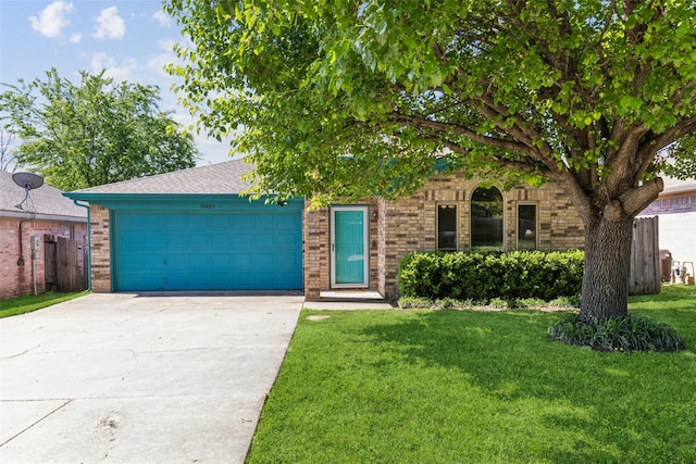 view of front of property with driveway, a front lawn, brick siding, and a garage