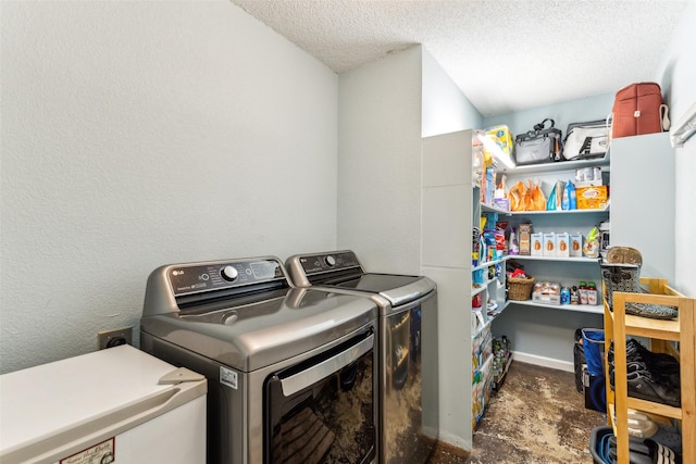 clothes washing area with a textured ceiling, washer and clothes dryer, and laundry area