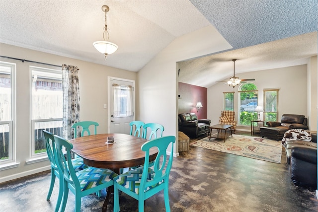 dining space featuring ceiling fan, vaulted ceiling, a textured ceiling, and a wealth of natural light