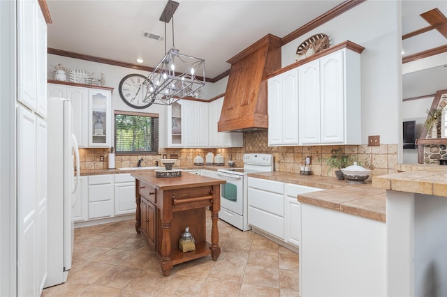 10248 N Poetry Ln, Terrell, TX 75160 - kitchen with tasteful backsplash, glass insert cabinets, white appliances, a chandelier, and crown molding