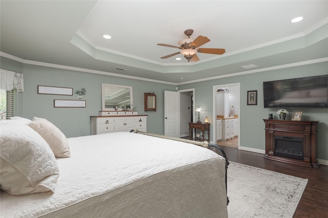 10248 N Poetry Ln, Terrell, TX 75160 - bedroom featuring recessed lighting, a fireplace, a tray ceiling, and dark wood finished floors
