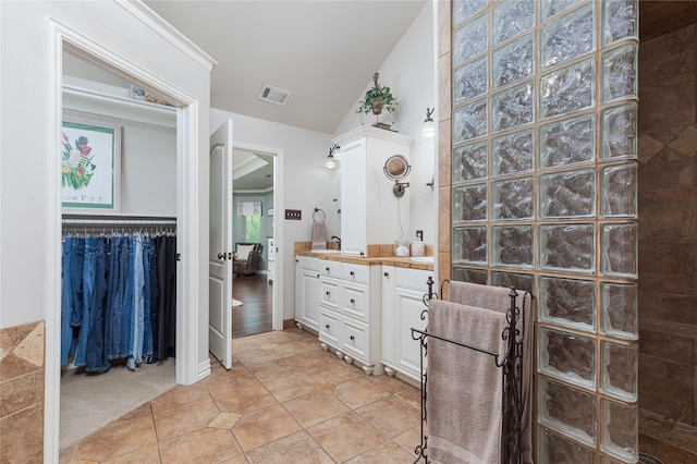 10248 N Poetry Ln, Terrell, TX 75160 - bathroom featuring a walk in shower, vanity, tile patterned flooring, visible vents, and lofted ceiling