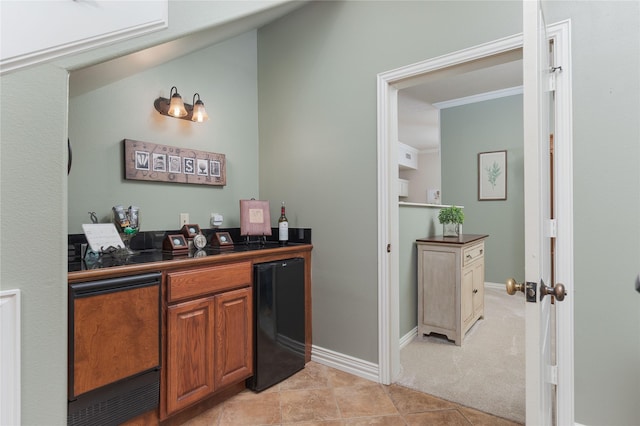 10248 N Poetry Ln, Terrell, TX 75160 - bar with light tile patterned floors, bar area, light carpet, baseboards, and fridge