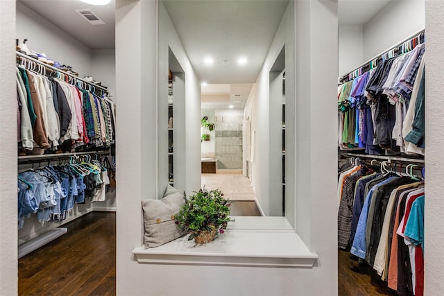 spacious closet featuring visible vents and wood finished floors