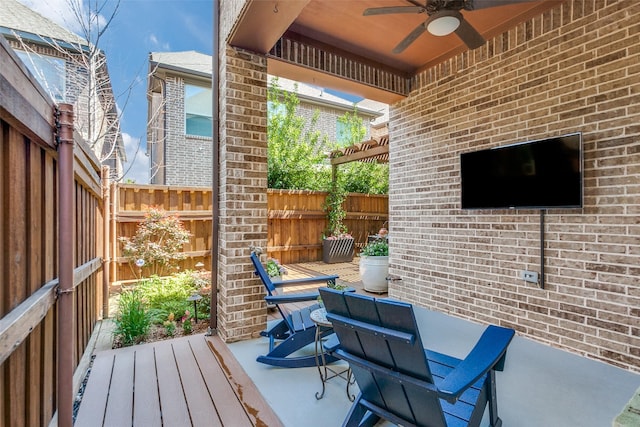 view of patio with fence and ceiling fan