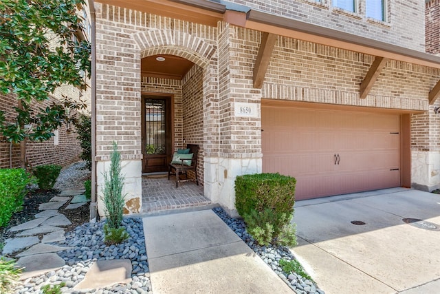 doorway to property featuring brick siding and concrete driveway