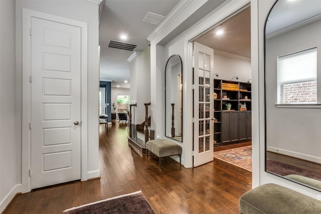 corridor featuring crown molding, recessed lighting, visible vents, and hardwood / wood-style flooring
