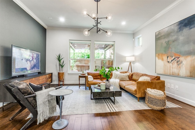 living area featuring a notable chandelier, baseboards, crown molding, and wood finished floors